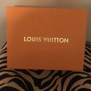 Empty gold Louis Vuitton pull box.
